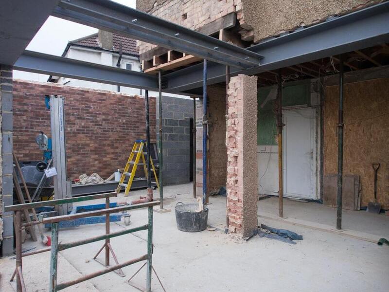 exposed-steel-beams-brick-extension-shell Keeping Every Trade Accountable on a Structural Job