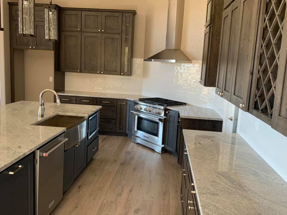 granite-worktop-island-in-dark-wood-kitchen What a Derby Worktop Fit Actually Involves (and Where the Costs Sit)
