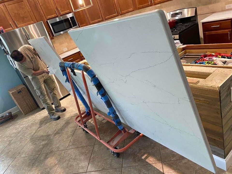 worker-moving-large-stone-worktop-slabs-on-trolley Worker moving a large stone worktop slab on a trolley for delivery